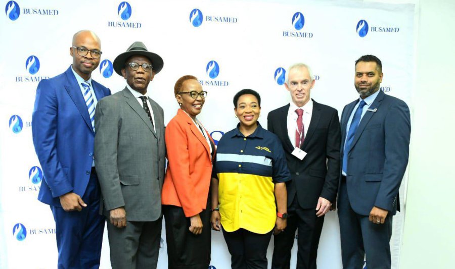 Partners and KwaZulu-Natal officials at the Busamed launch of the arthroplasty partnership, in front of a Busamed backdrop.